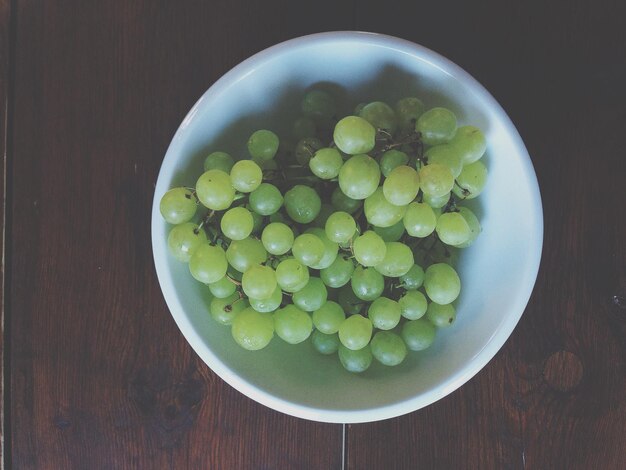 Um feixe de uvas verdes numa tigela.