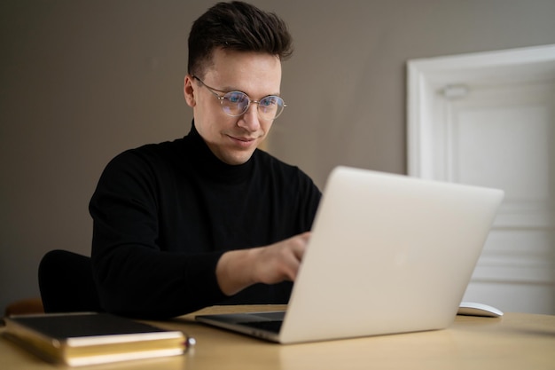 Um freelancer trabalha um homem no escritório usa um laptop