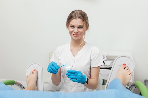 Um ginecologista é examinado por uma paciente que está sentada em uma cadeira ginecológica