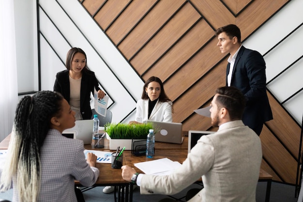 Um grupo de empresários de diferentes nacionalidades durante uma reunião de brainstorming em um elegante escritório