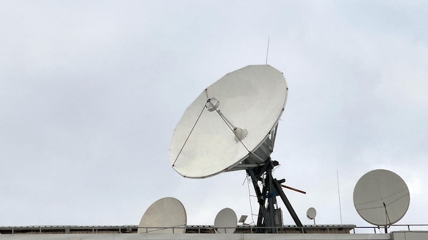 Foto um grupo de grandes satélites terrestres são apontados para cima uma grande antena parabólica pesquisa o céu