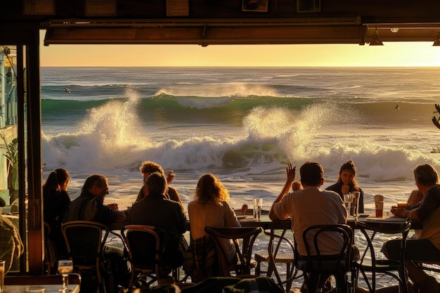 Foto um grupo de pessoas sentadas em uma mesa em frente ao oceano