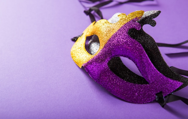 Um grupo festivo, colorido de carnaval ou máscara carnivale em um fundo roxo. Máscaras venezianas.