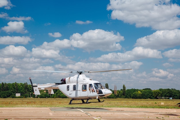 Um helicóptero branco decola da pista