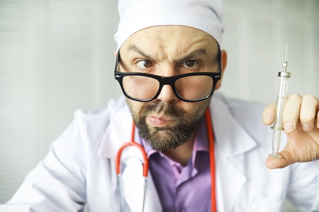 Um homem barbudo vesgo está olhando para o quadro Doença ocular O conceito de um médico especialista louco Médico vizinho