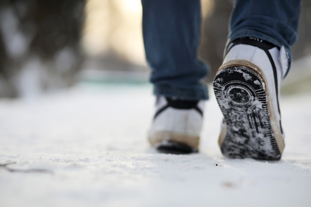 Um homem caminha pela cidade em um dia nevado de inverno.