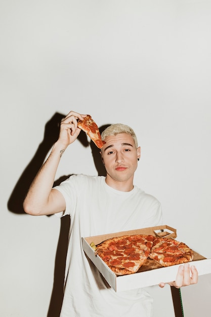 Foto um homem comendo uma pizza de calabresa