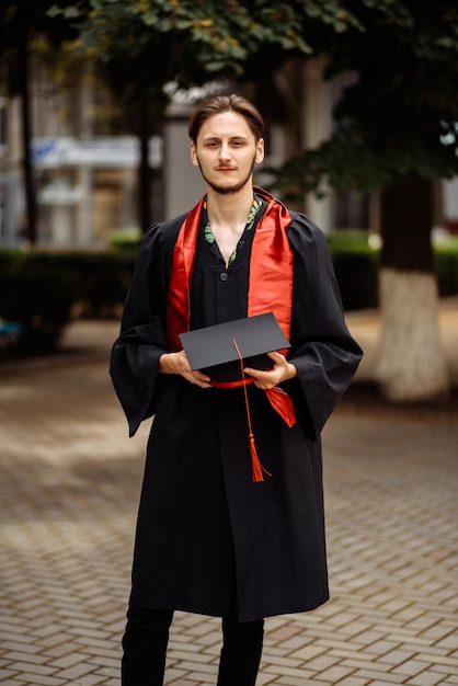 Foto um homem de roupa preta está segurando um livro