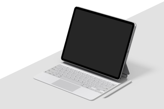 Um laptop com teclado branco está sobre uma mesa com suporte preto.