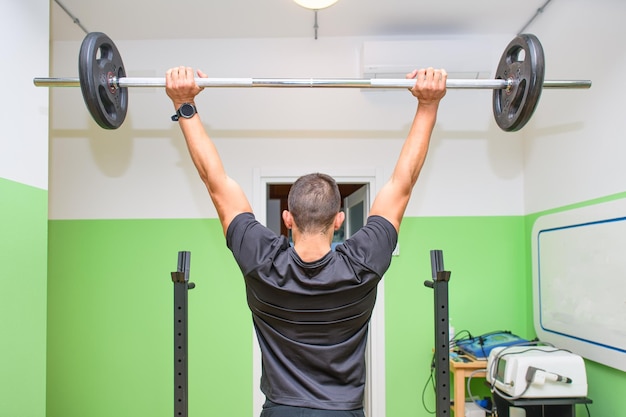 Um menino com powerlifting no ginásio