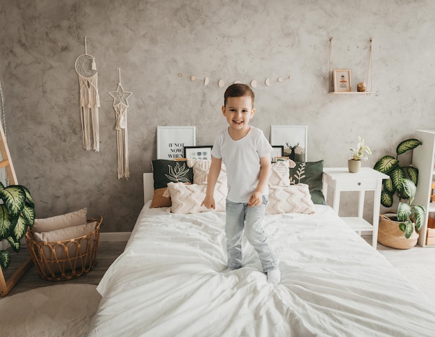 Um menino de 5 anos pula na cama dos pais em casa