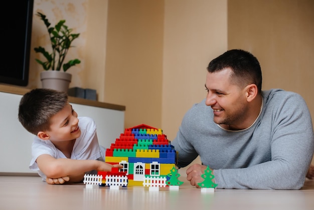 Um menino junto com seu pai é interpretado por um construtor e constrói uma casa. Construção de uma casa de família.