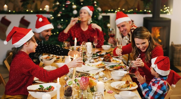 Um Natal divertido repleto de memórias familiares especiais Foto de uma família feliz almoçando juntos em casa
