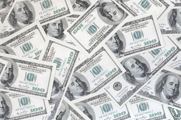 Um padrão de muitas notas de dólar. Imagem de fundo