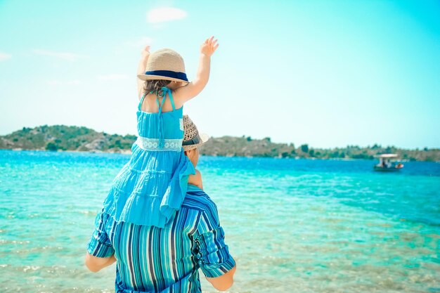 Um pai com filhos na natureza no parque perto do fundo da viagem marítima