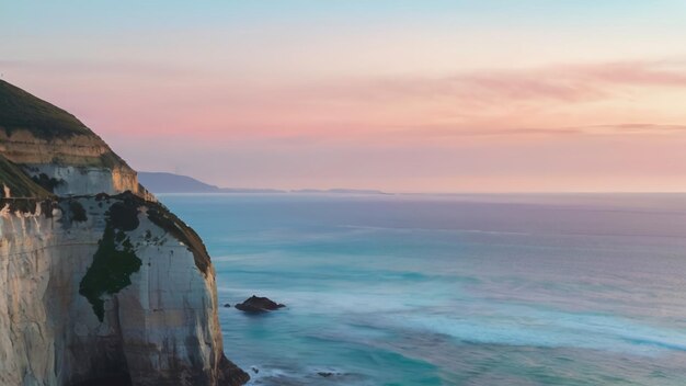 Foto um penhasco de frente para o oceano, cor pastel.