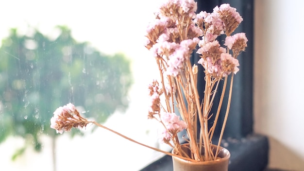 Um pequeno vaso exibido na janela. Buquê de flores perto de janela com cortina. ideia de estilo de vida para morar em casa