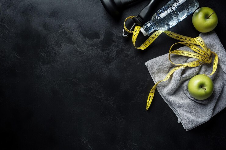 Foto um plano de treino com equipamentos de fitness em fundo escuro vista superior