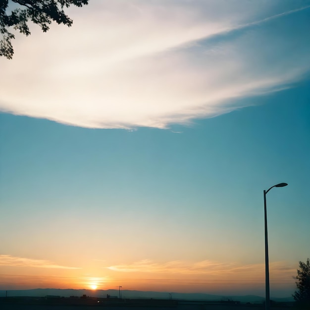 um pôr-do-sol com uma luz de rua e uma luz de estrada