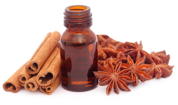 Um pouco de canela aromática com anis estrelado e óleo essencial em uma garrafa