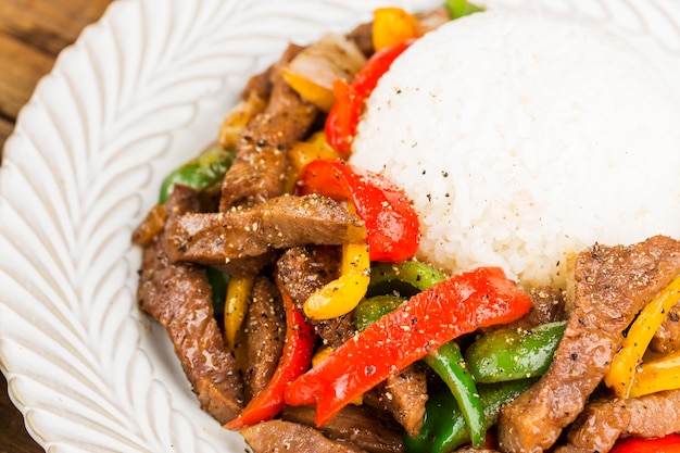 Um prato de arroz de carne frita com pimenta verde