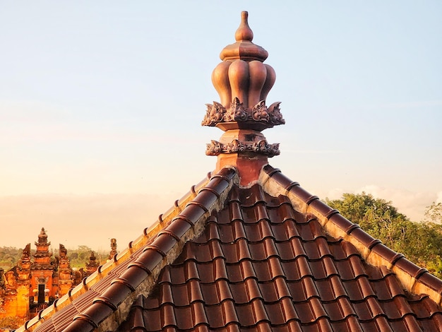 Um telhado vermelho com um telhado de telha marrom com um desenho decorativo nele.
