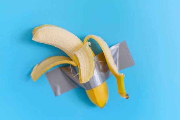 Uma banana aberta é gravada em um fundo azul