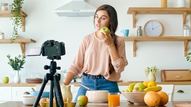 Uma bela jovem gravando um blog sobre culinária Vídeo Blog sobre alimentação saudável