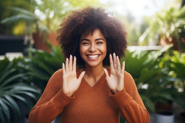 Foto uma bela mulher sorridente a fazer uma forma de coração com as mãos em close-up, uma afro-americana muito alegre.