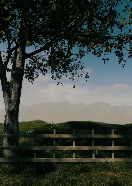 Uma cerca com uma árvore e montanhas ao fundo
