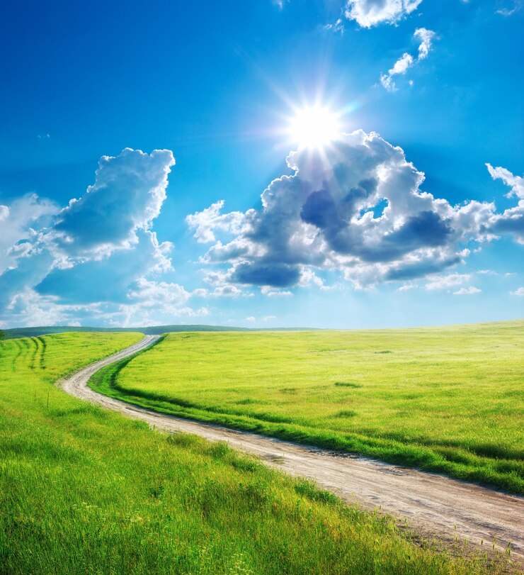 Foto uma estrada de terra leva a um campo com uma estrada e um céu com nuvens
