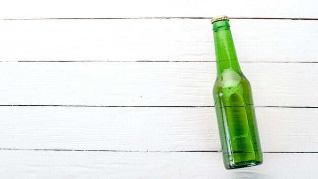 Uma garrafa de cerveja em um fundo de madeira Espaço livre para texto Vista superior