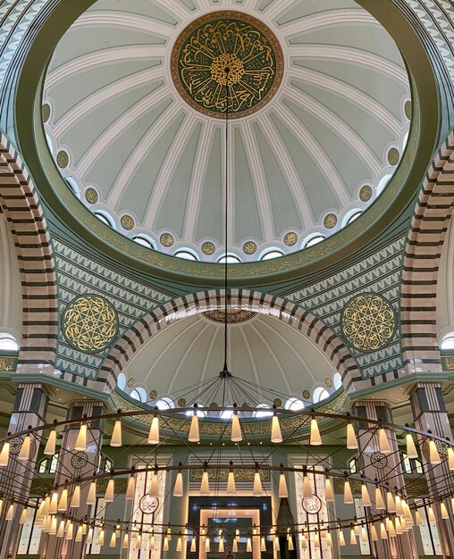 Uma grande cúpula com um desenho verde e dourado no teto