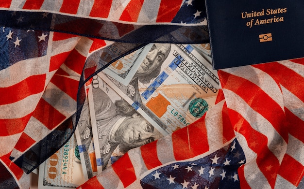 Uma grande quantidade de dinheiro de US $ 100 em passaportes americanos no símbolo nacional da bandeira dos EUA