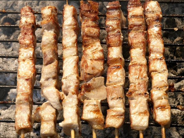 Uma grelha com carne e a palavra "churrasco" embaixo.