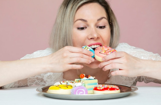 Foto uma linda mulher comendo biscoitos