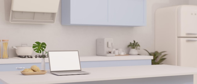 Uma maquete de laptop em uma ilha de cozinha branca em cozinha minimalista em estilo branco e azul