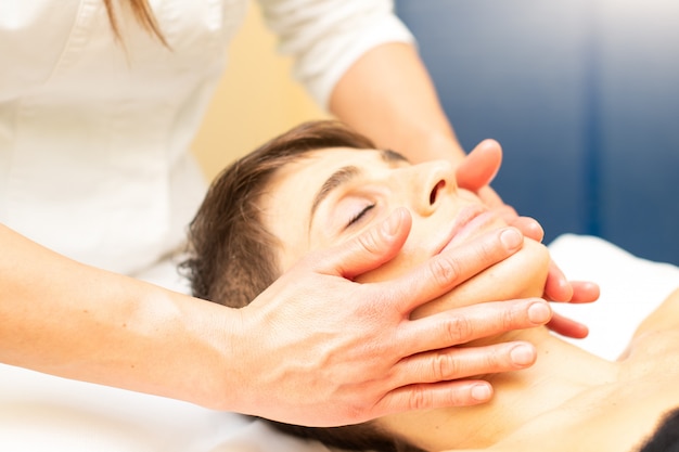 Uma massagem facial relaxante em um estudo estético