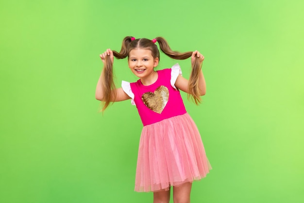 Uma menina de vestido brincando com o cabelo