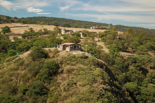 Foto uma montanha com uma casa no topo no arcos del site ecopark em tepotzotlan, méxico