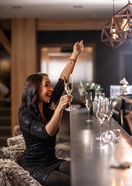 Foto uma morena bonita está a celebrar o ano novo no bar mesmo depois do fim da manhã.