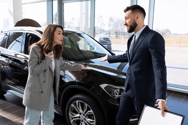 Uma mulher defende seus direitos em uma concessionária de carros ao comprar um carro com defeito