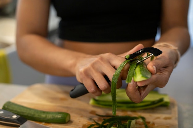 Foto uma mulher descasca pepino que protege as células nervosas, melhora a memória e previne a doença de alzheimer