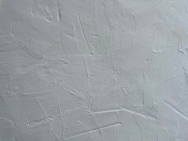 Uma parede branca com uma superfície texturizada áspera.