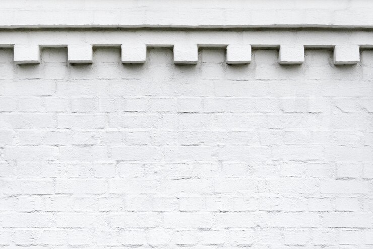 Foto uma parede de tijolos brancos com friso ornamental decorativo no topo