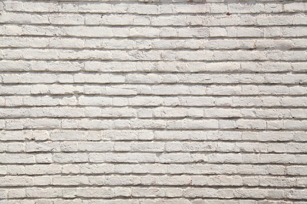 Uma parede de tijolos brancos com uma textura áspera