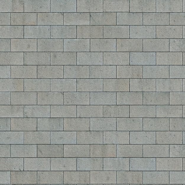 Uma parede de tijolos cinza com uma base branca e uma base preta.