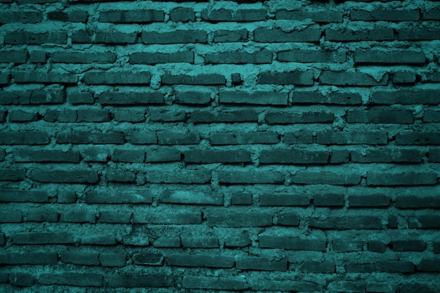 Foto uma parede de tijolos verdes com uma parede de tijolos que diz 