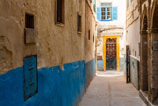 Uma pequena rua na medina de Essaouira em Marrocos A parte inferior das paredes é pintada de azul