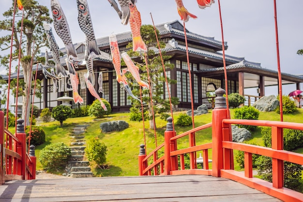 Uma ponte vermelha sobre a água em um jardim japonês